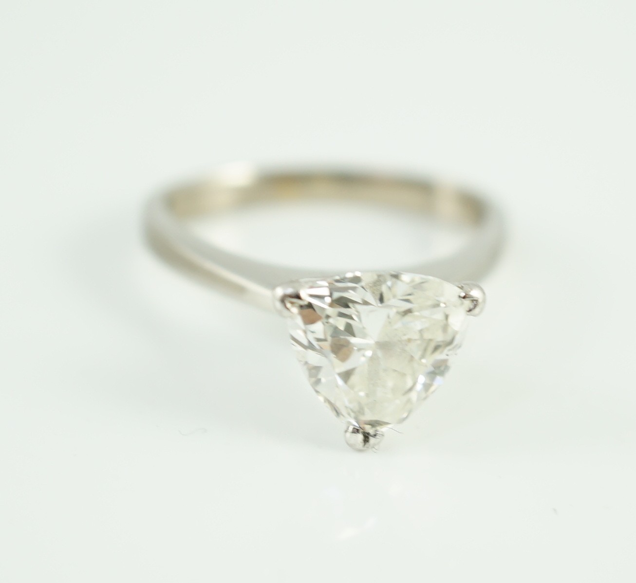 A modern platinum and solitaire trillion cut diamond set ring